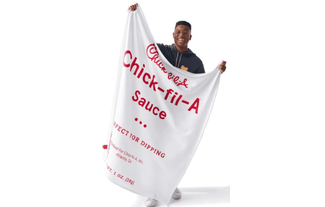 Black male holding Sauce Blanket and Nugget Pillow Set​