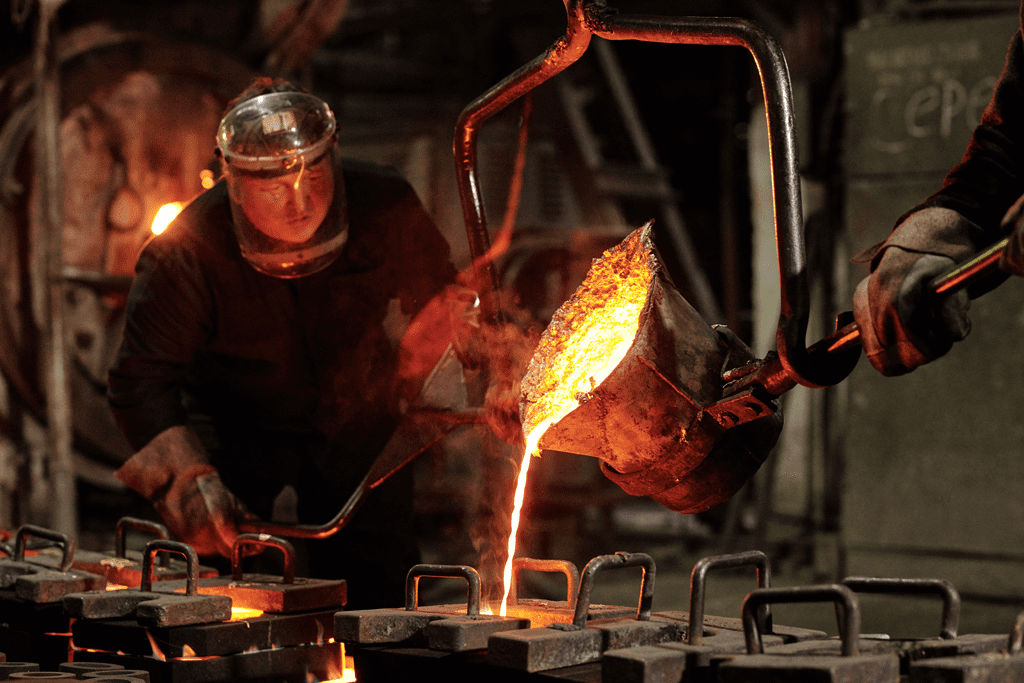 foundry worker pouring molten metal for die-casting
