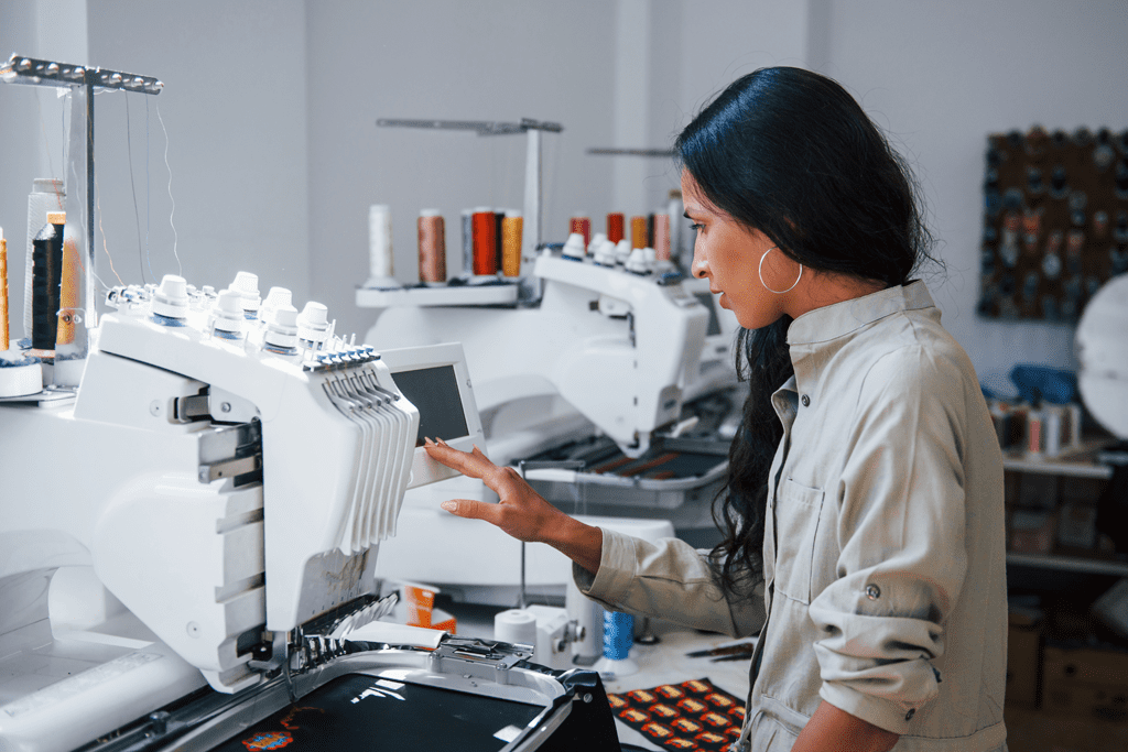 woman working a computerized embroidery machine