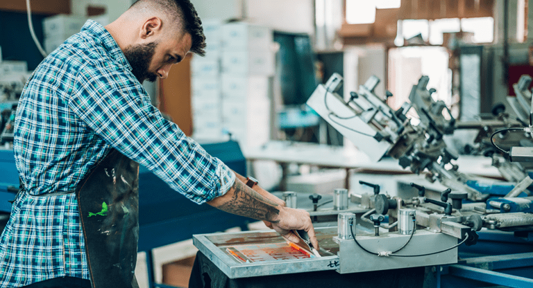 man screen printing a T-shirt