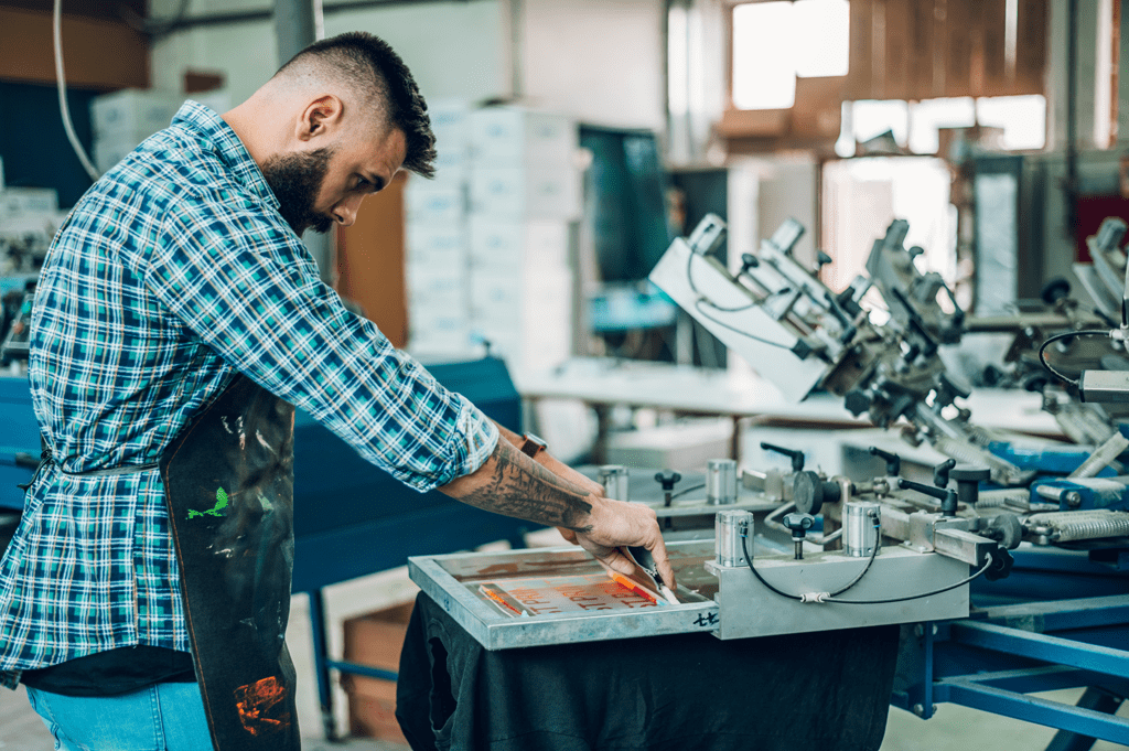 man screen printing a T-shirt