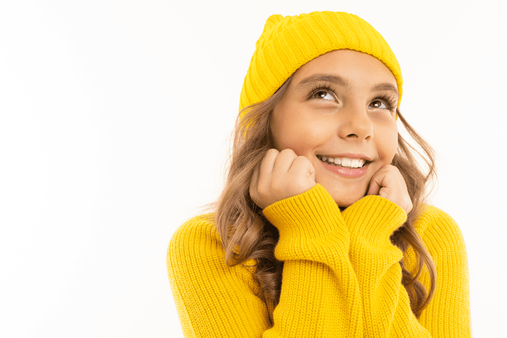 girl in yellow sweater and knit beanie