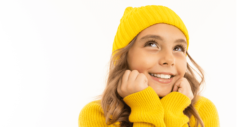 girl in yellow sweater and knit beanie