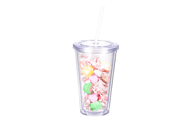 clear reusable tumbler with straw filled with individually wrapped salt water taffy candies