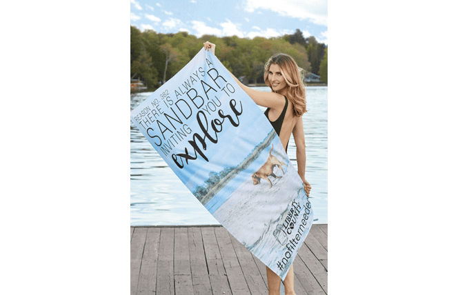 woman displaying custom-printed beach towel