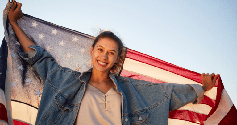 young-woman-holding-us-flag 1200x
