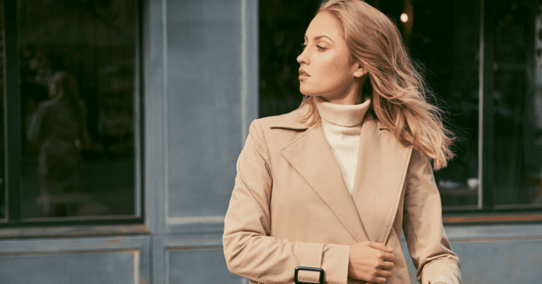 blonde woman in camel trench coat - stealth wealth - quiet luxury