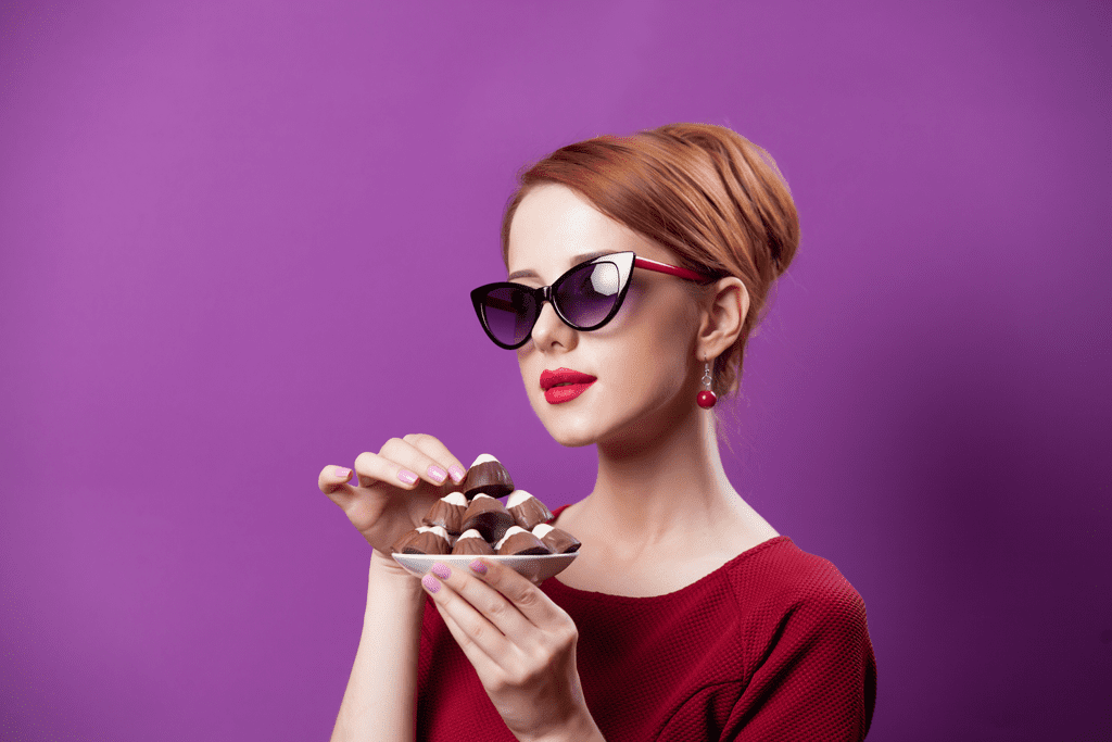woman enjoying chocolate candies